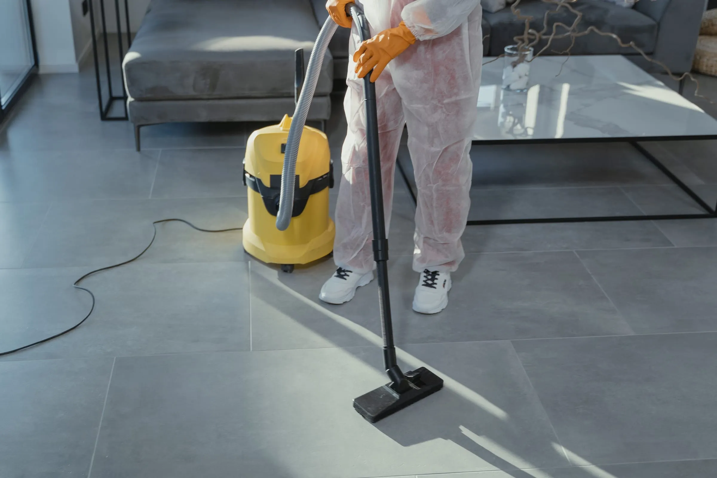 Hard tile flooring being vacuumed in a modern living space